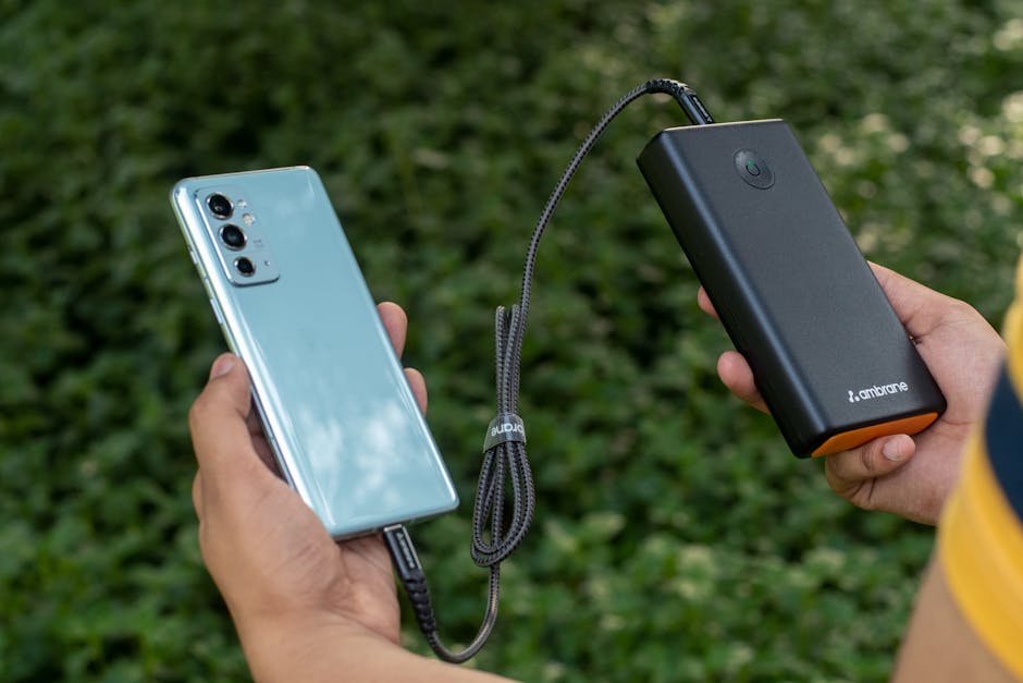 An Anker USB-C Power Bank charging a smartphone while camping in a remote location