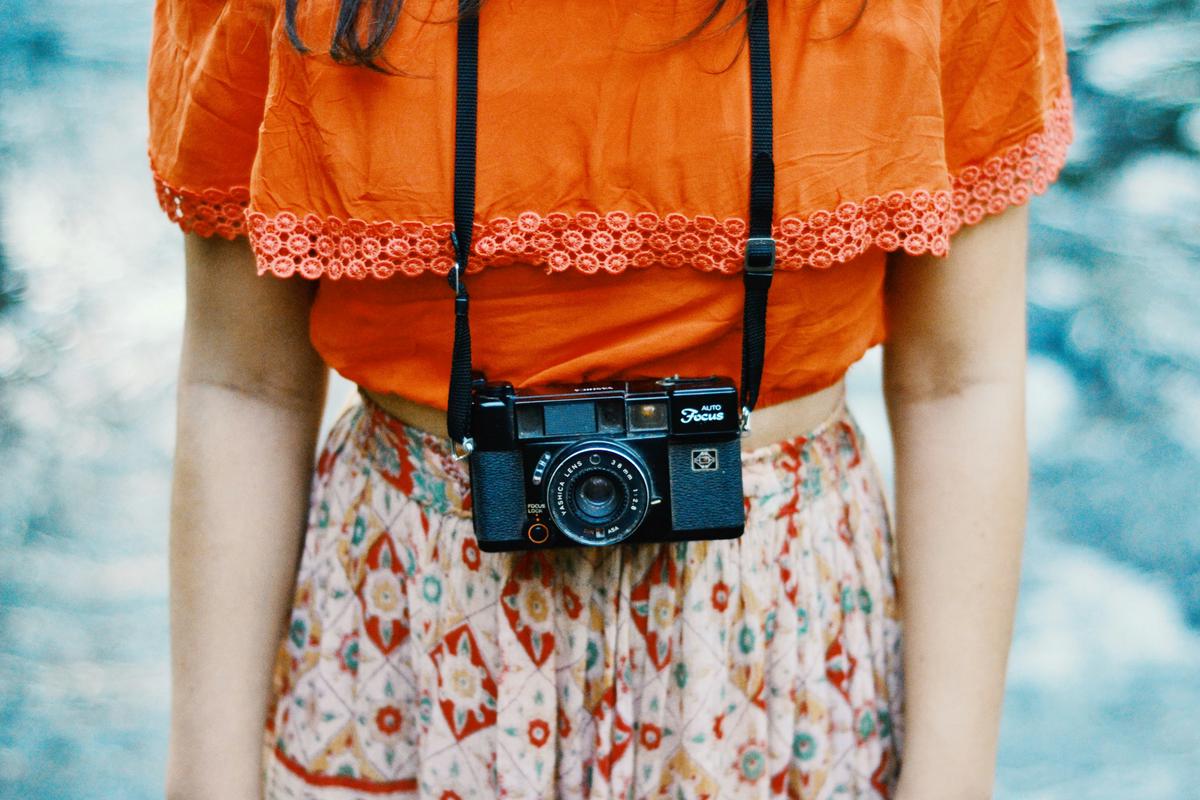 A fashion photographer holding a camera at a fashion show